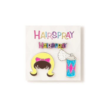Two enamel pins on a card with 'Hairspray' text, one featuring a character with a bow and the other a can of hairspray. inspired by the John Waters movie HAIRSPRAY (1988)